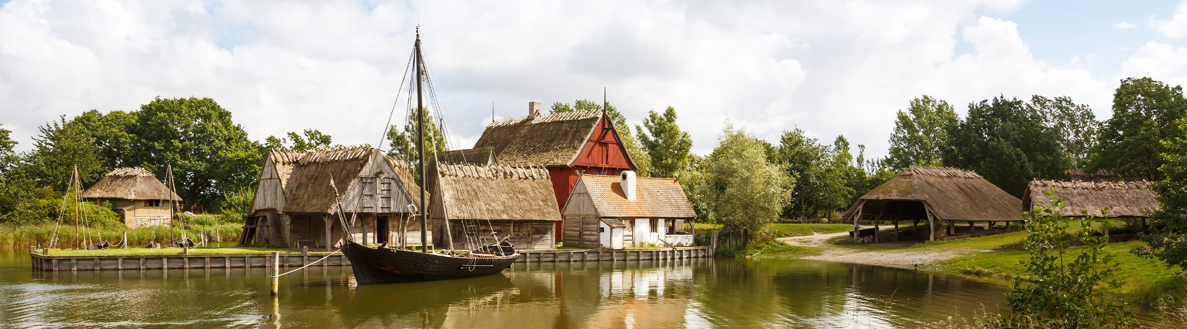 The medieval houses and boats in The Middle Ages Center, the experimental living history museum in Sundby Lolland, Denmark.